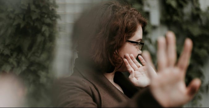 man in brown sweater wearing black framed eyeglasses