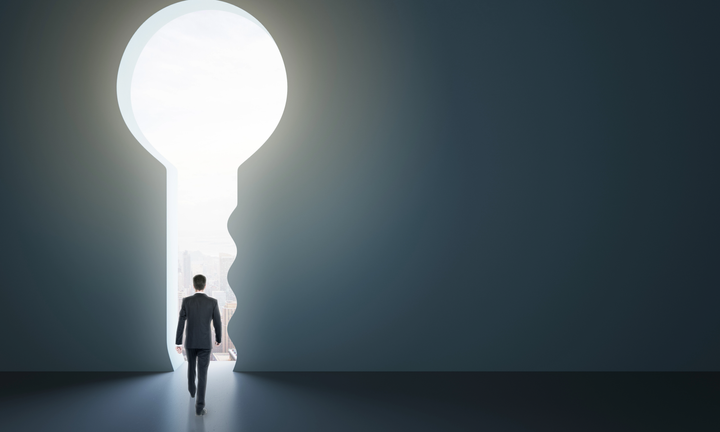 Person walking through keyhole-shaped doorway, symbolizing access to new possibilities in AI.